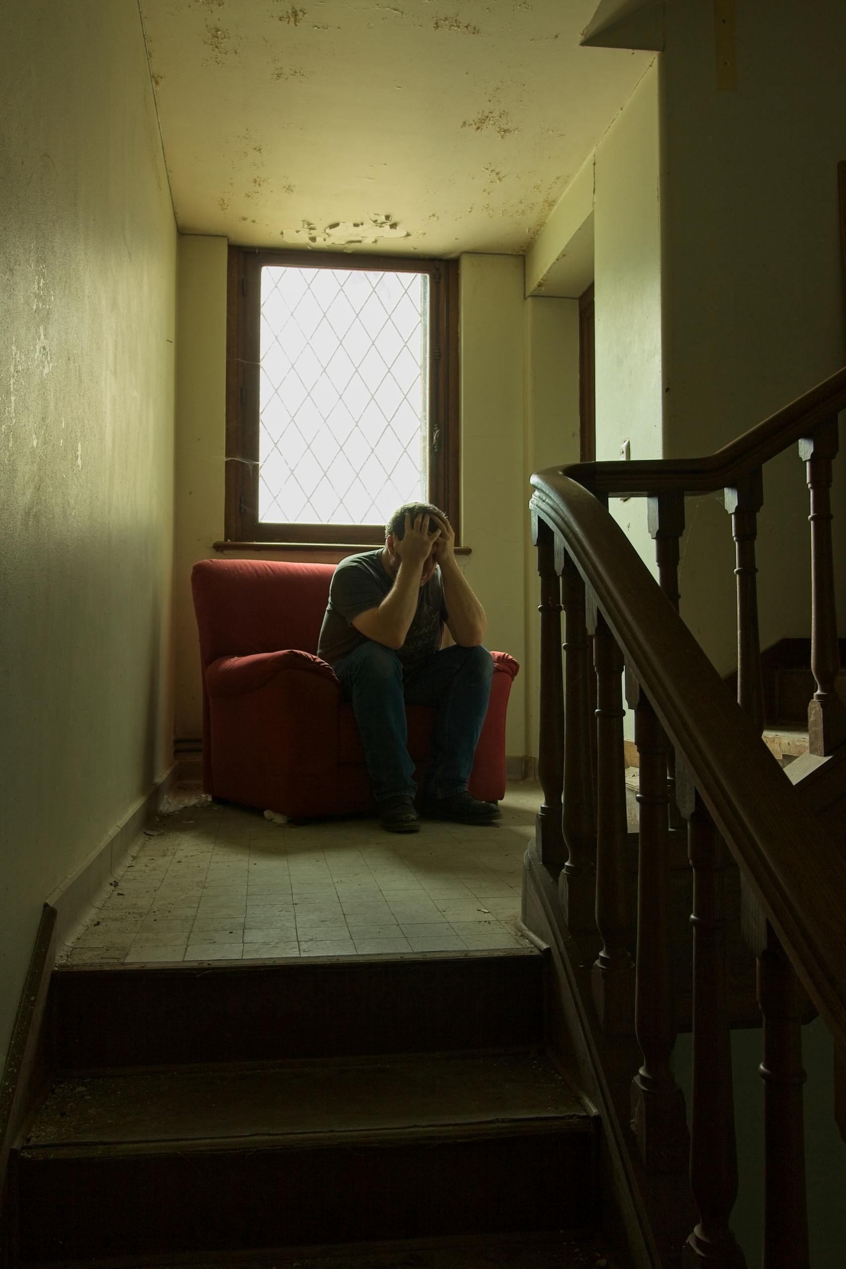 Depressed Man in Neglected Building